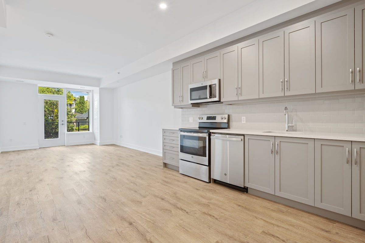 white wooden kitchen cabinet near white wall