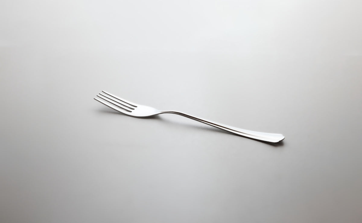 a fork that is laying on a table