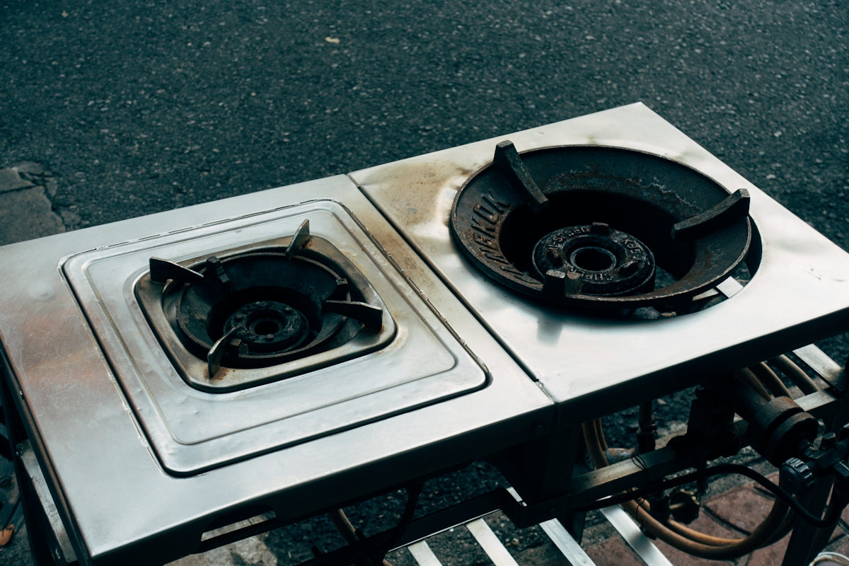 two burners sitting on top of a metal table