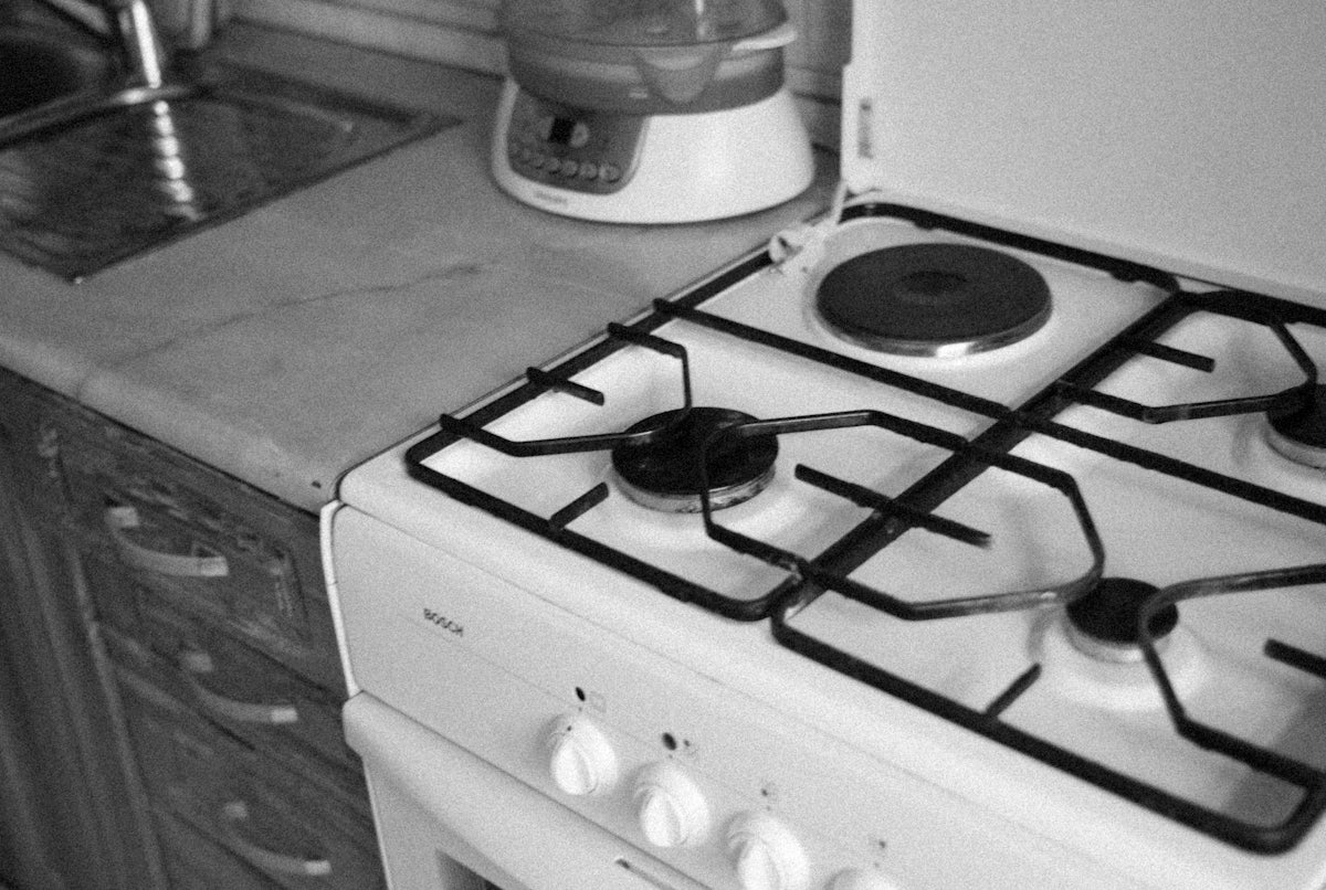 a white stove top oven sitting next to a counter