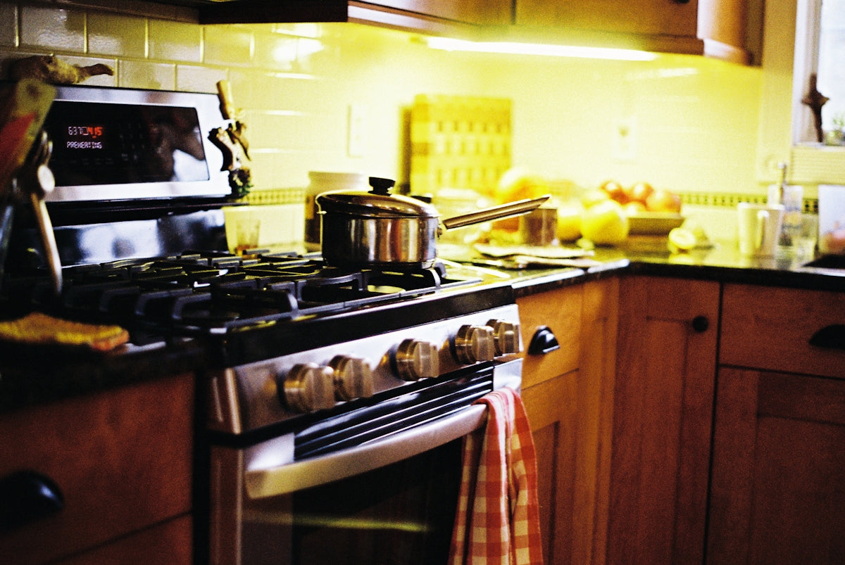 a stove top oven sitting inside of a kitchen