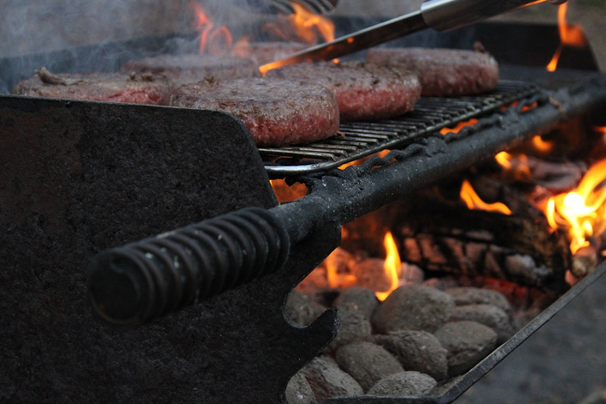 a grill with meat and fire