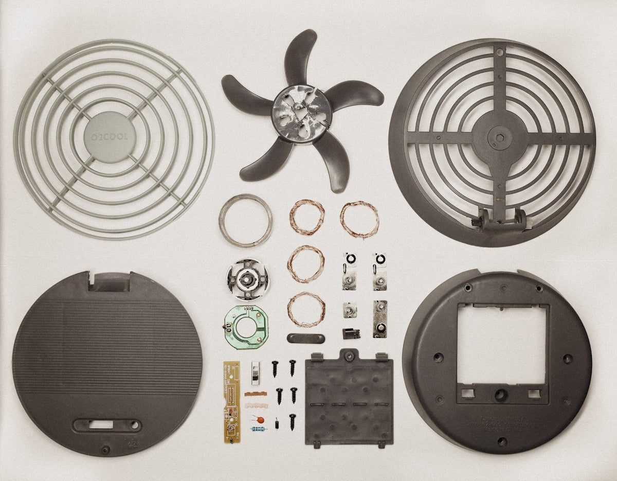 a picture of a fan, parts, and tools on a white background