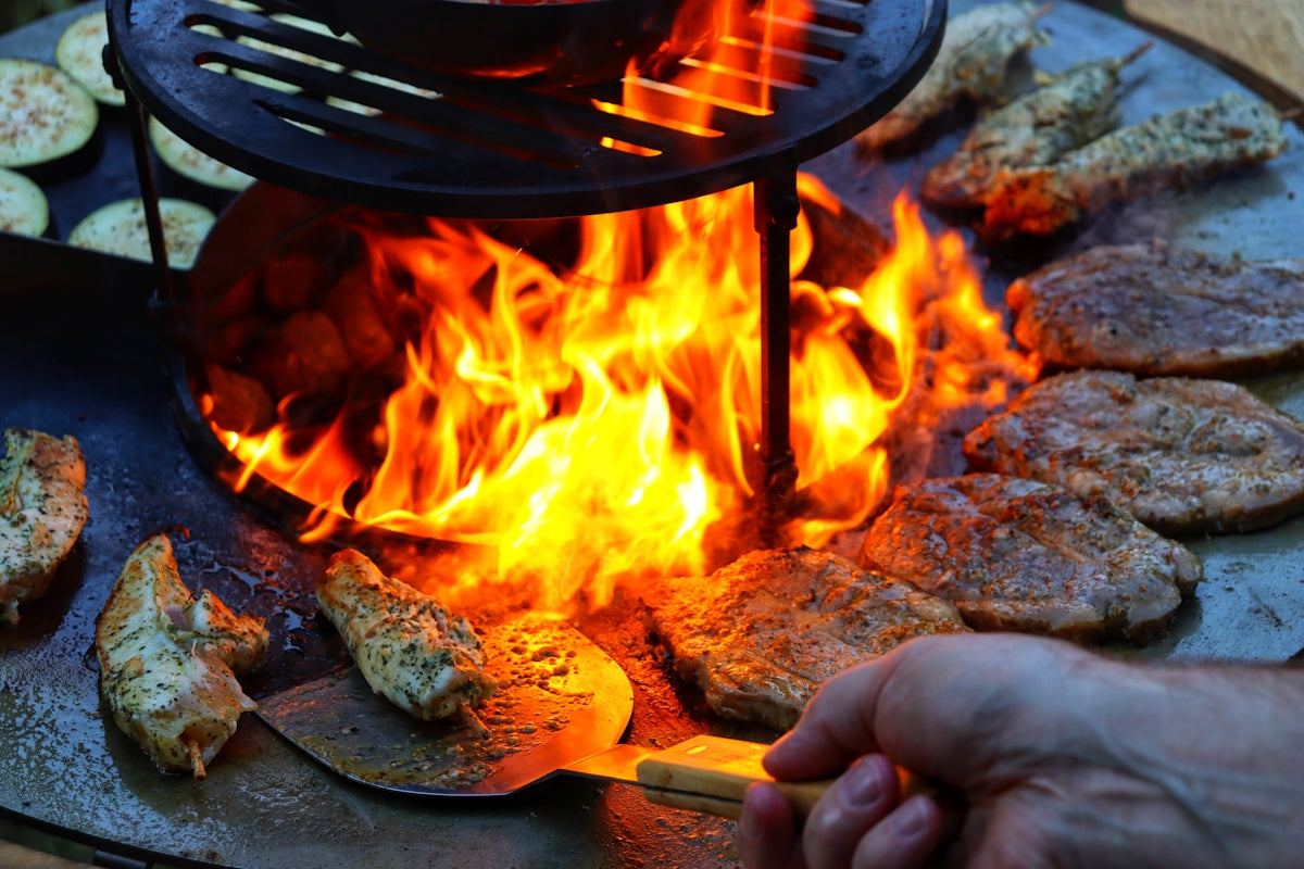 a person is cooking food on a grill