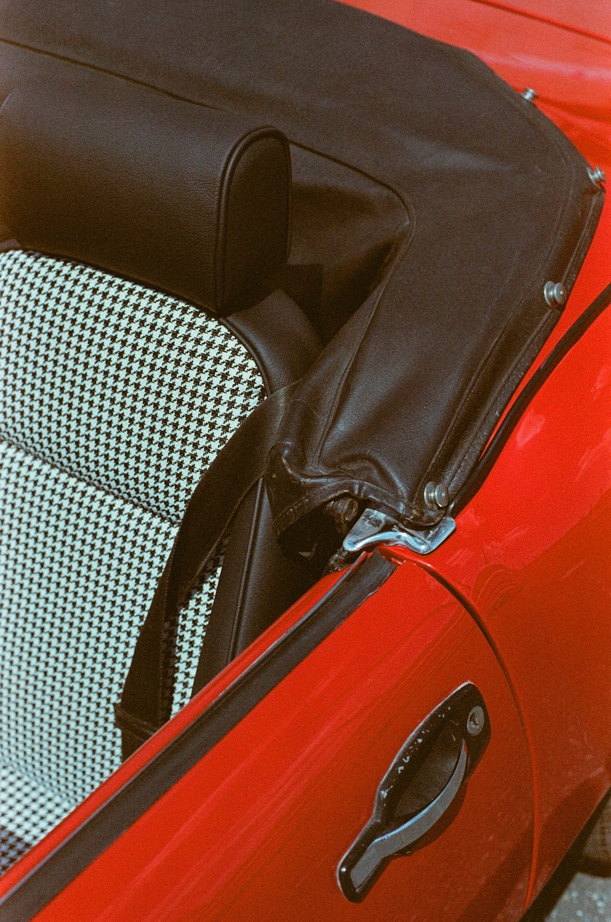a close up of a red car with a black and white seat