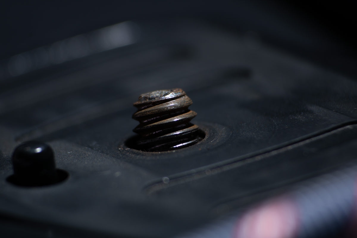 a close up of a drop of water on a black surface