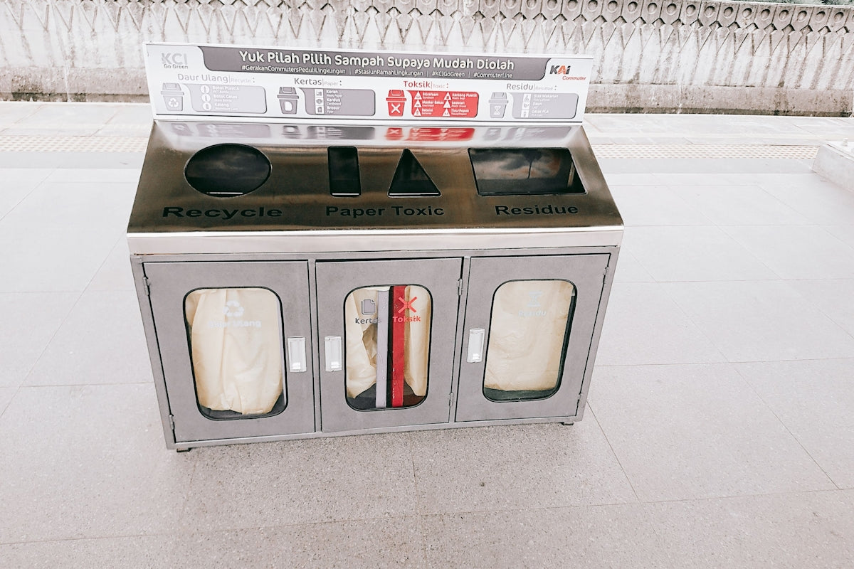 a newspaper dispenser sitting on a sidewalk