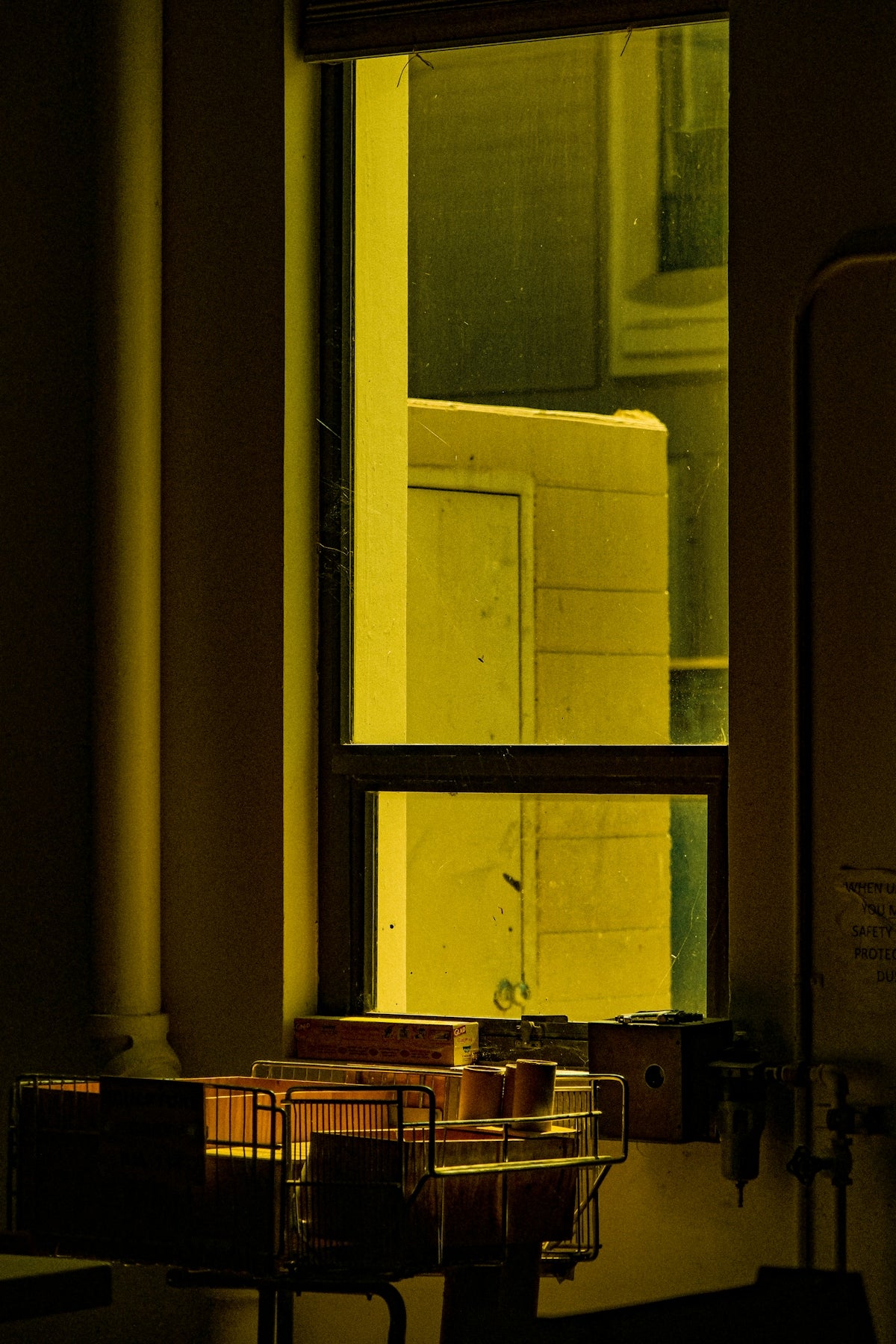 a room with a window and a basket in it