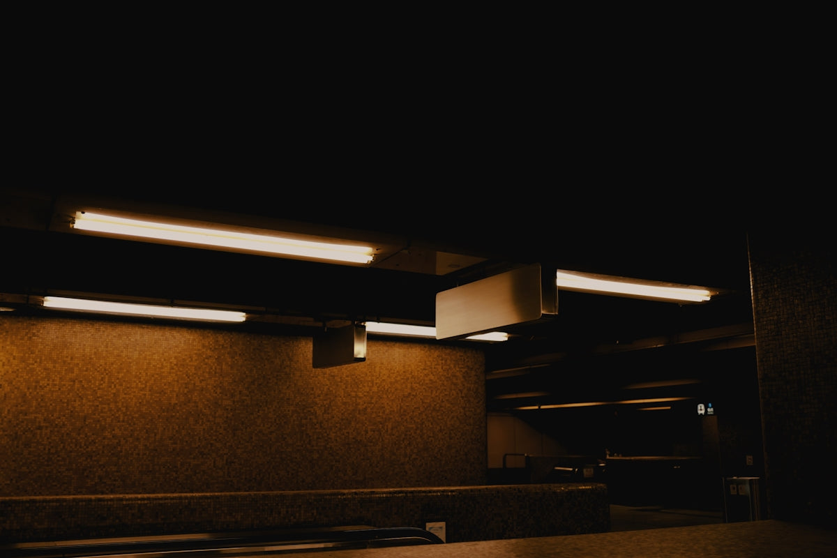 a dimly lit room with benches and lights
