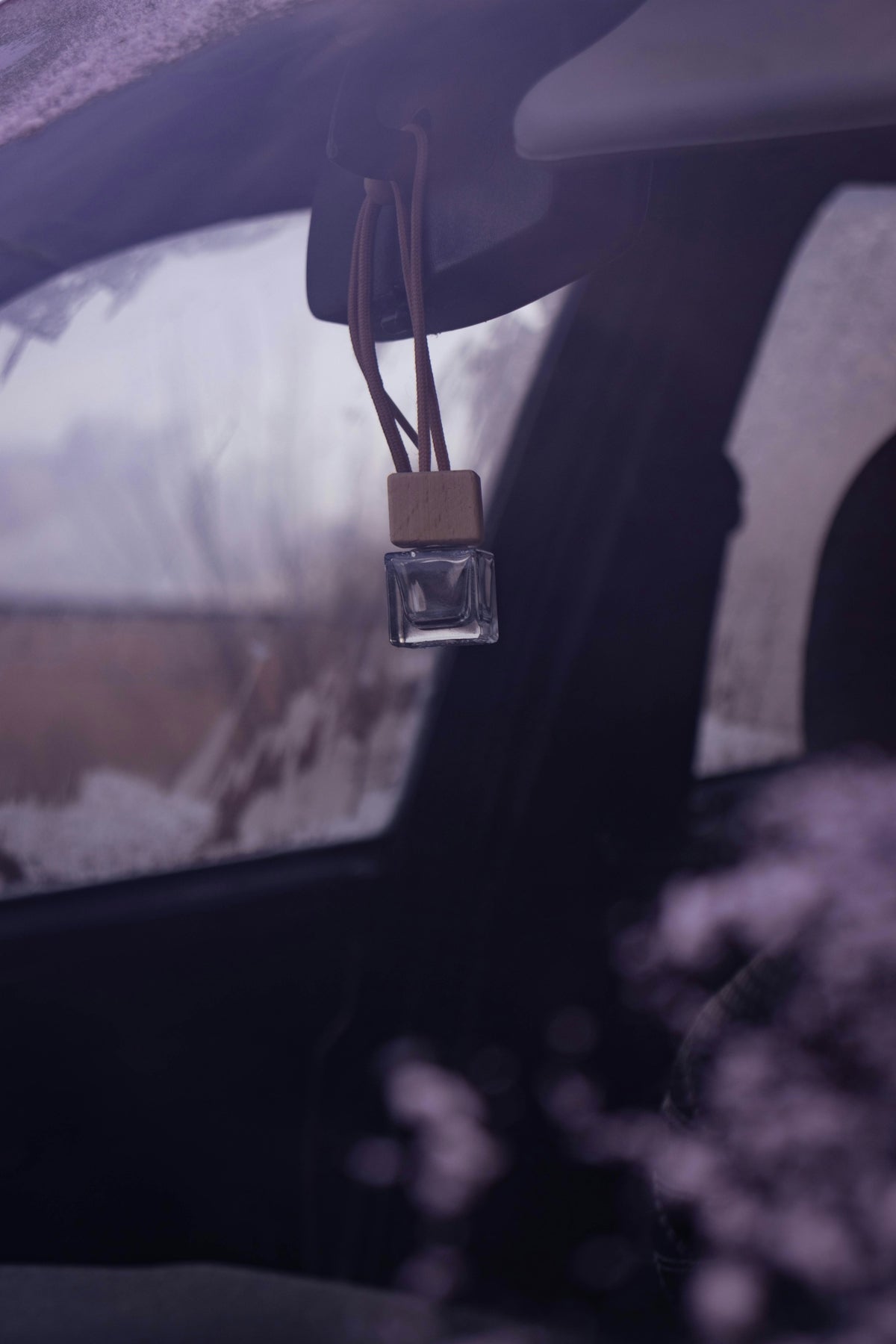a car dashboard with a brown tag hanging from it's side window
