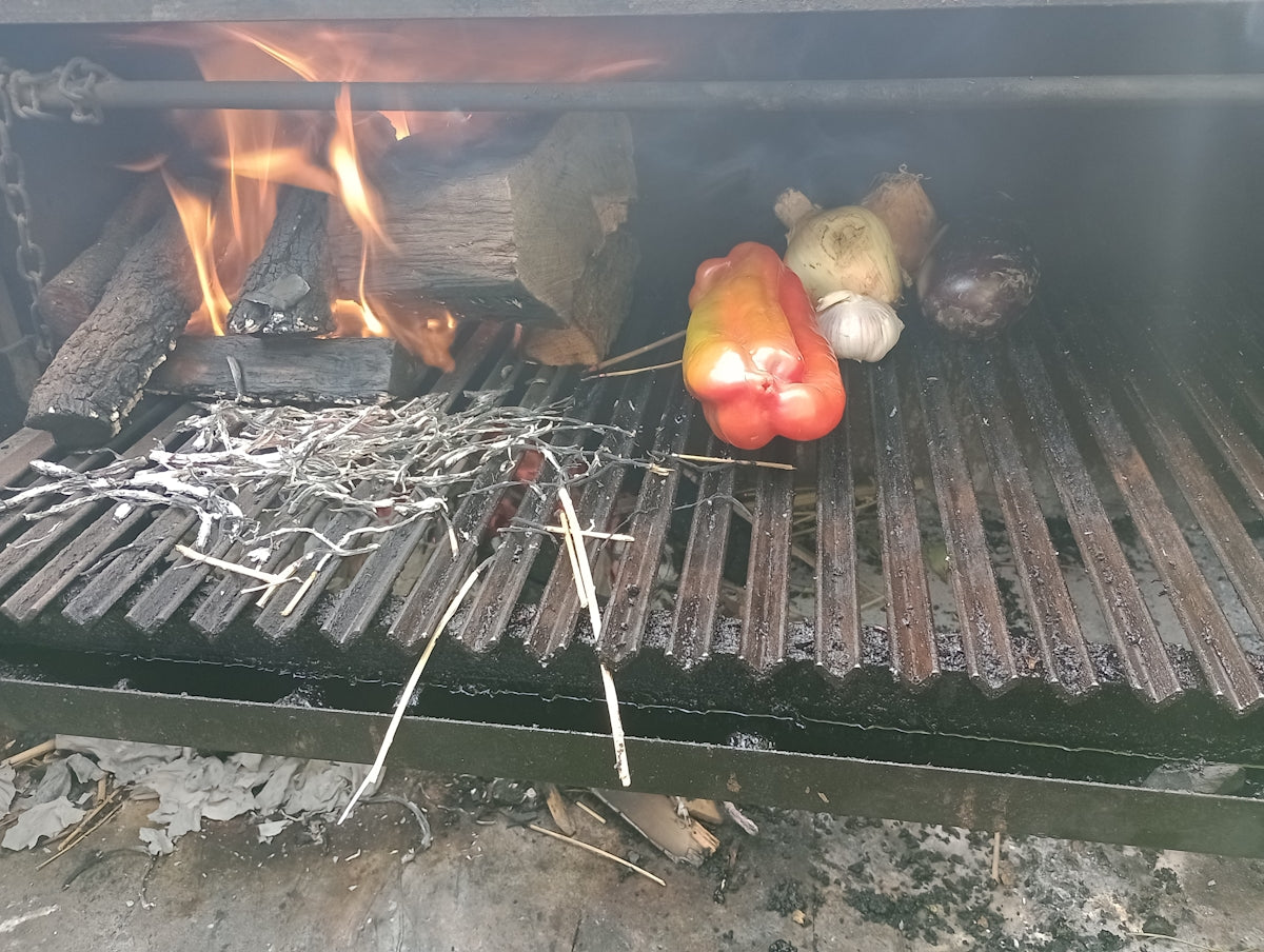 a grill that has some vegetables cooking on it