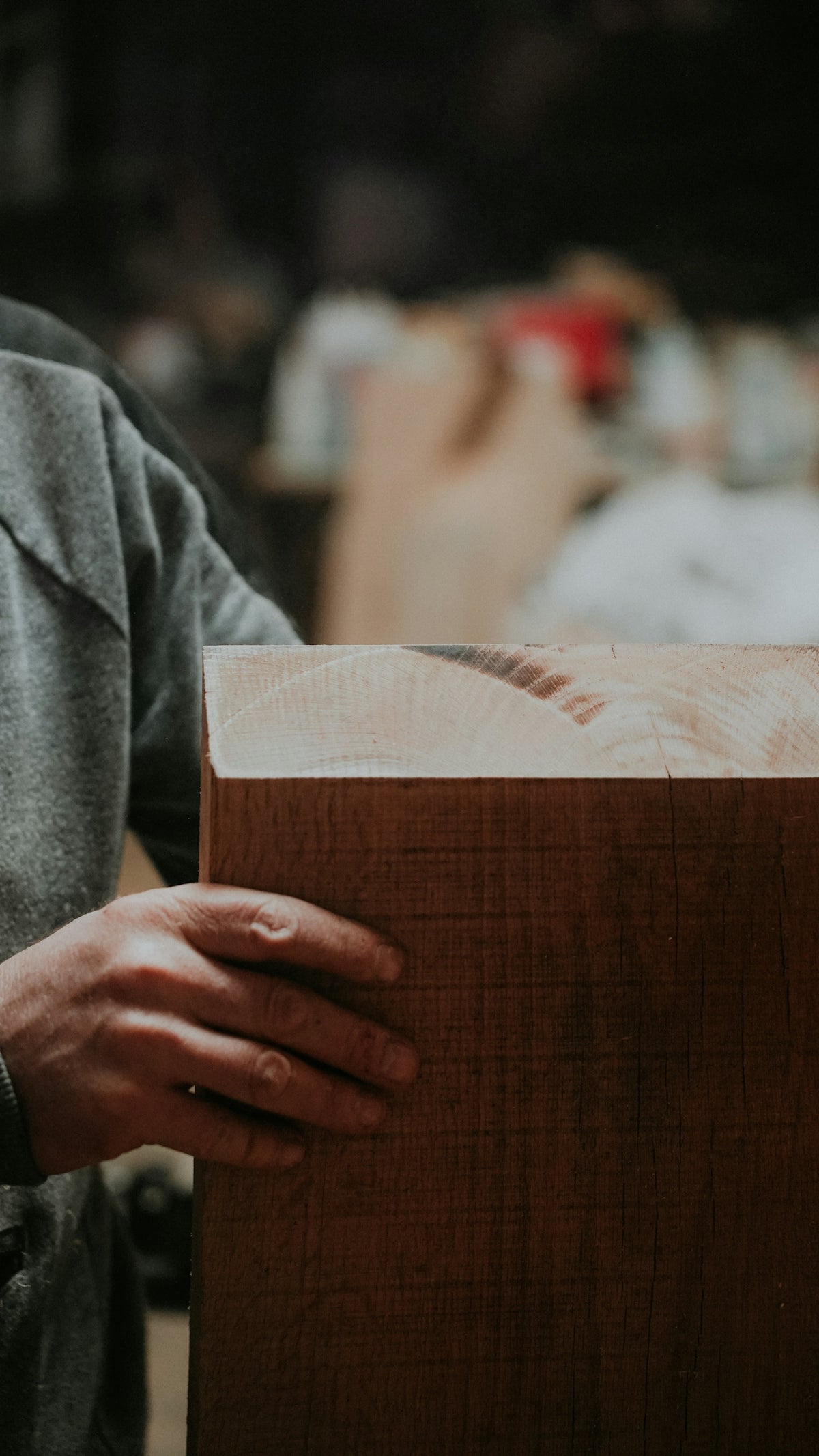 a close up of a person holding a piece of wood