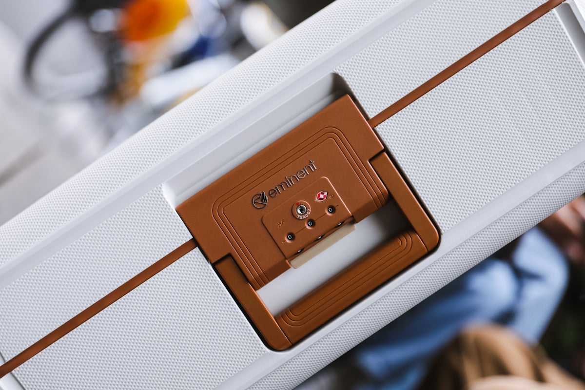 a close up of a white suitcase with a brown handle