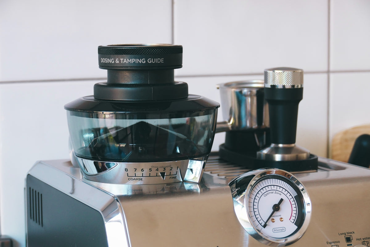 a blender sitting on top of a counter next to a clock