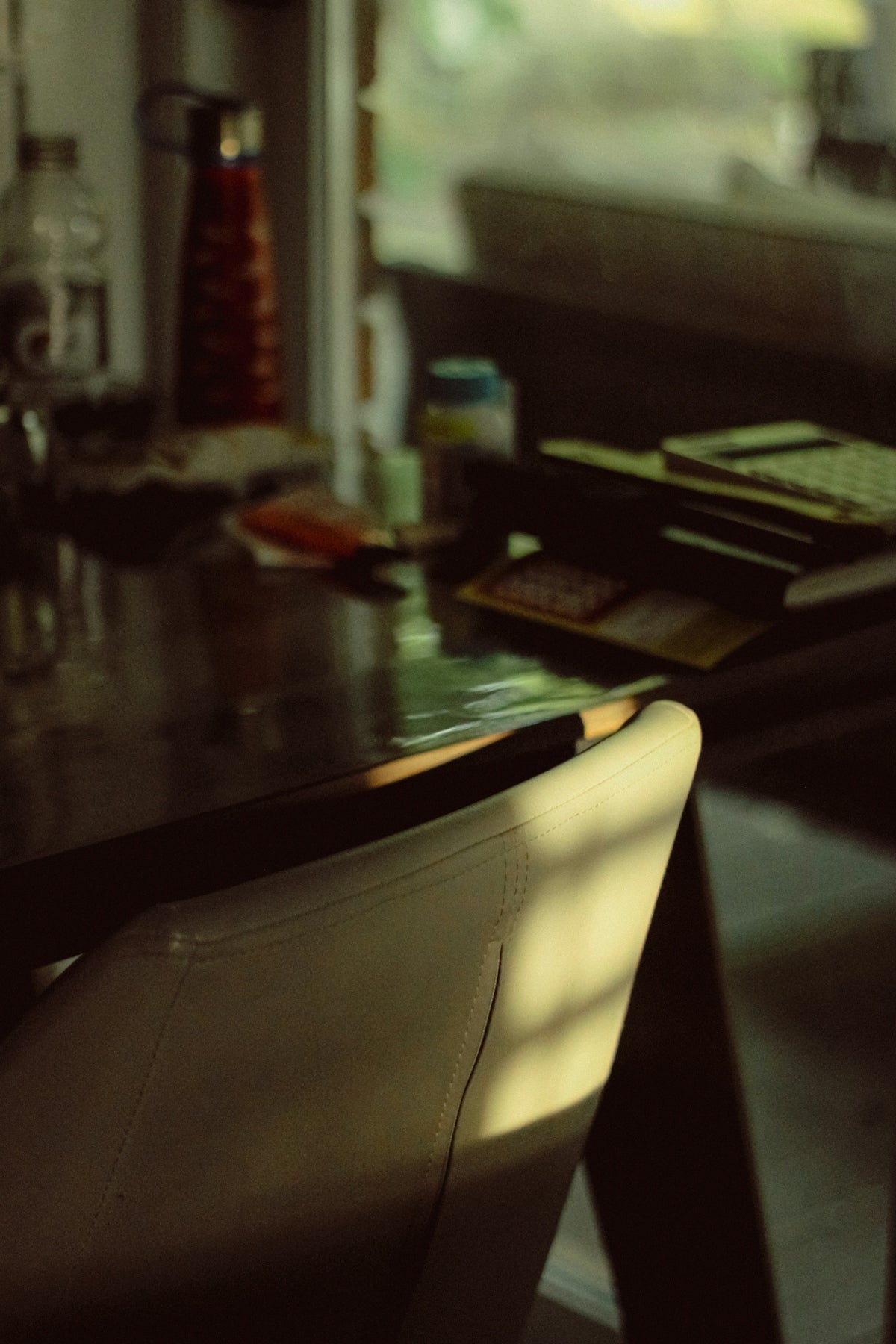 a table with a chair and a bottle of wine on it