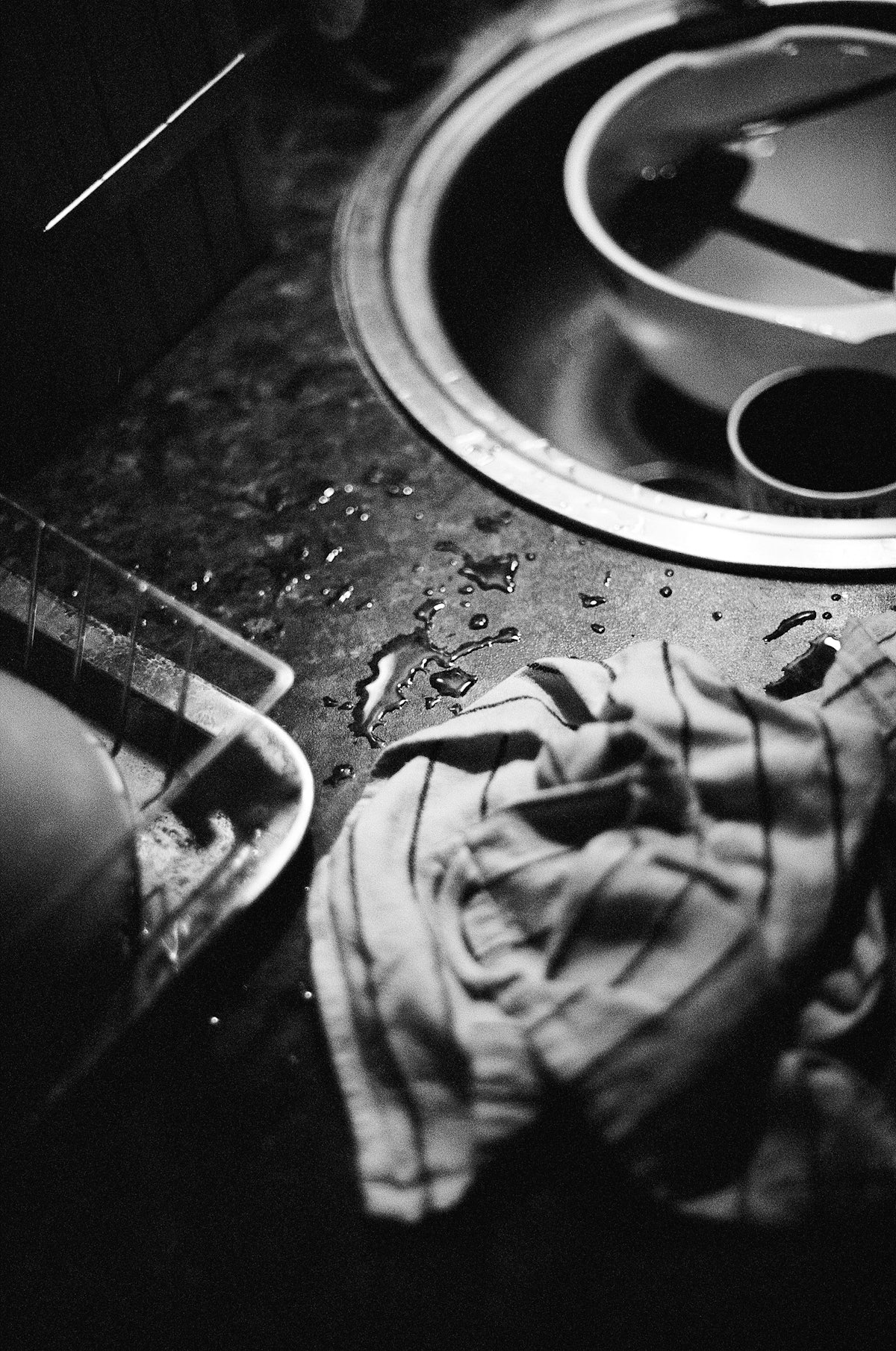 A dirty dishwasher with a dirty cloth on the floor