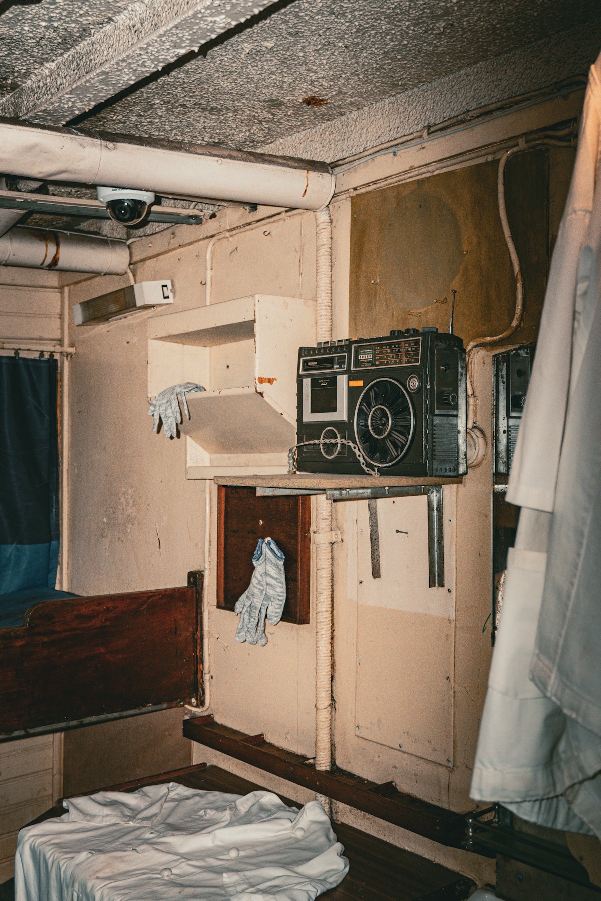 A room with a bed and a radio in it