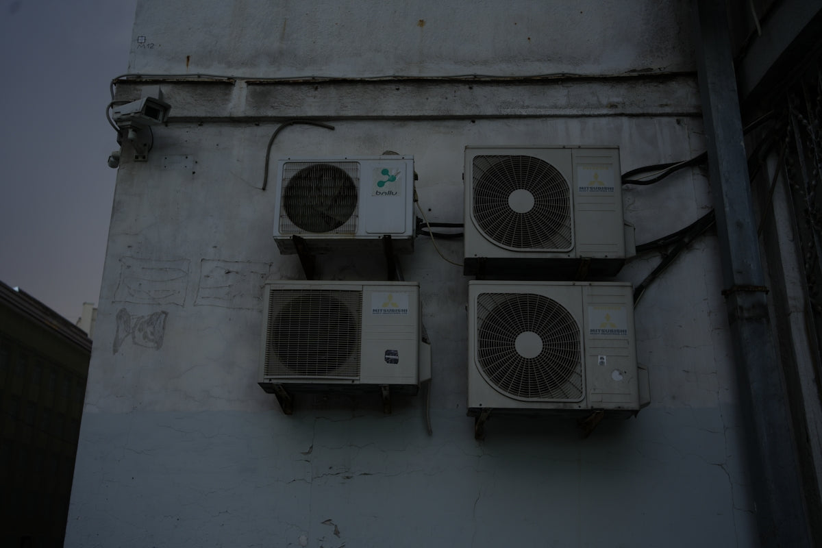 A group of speakers mounted to the side of a building