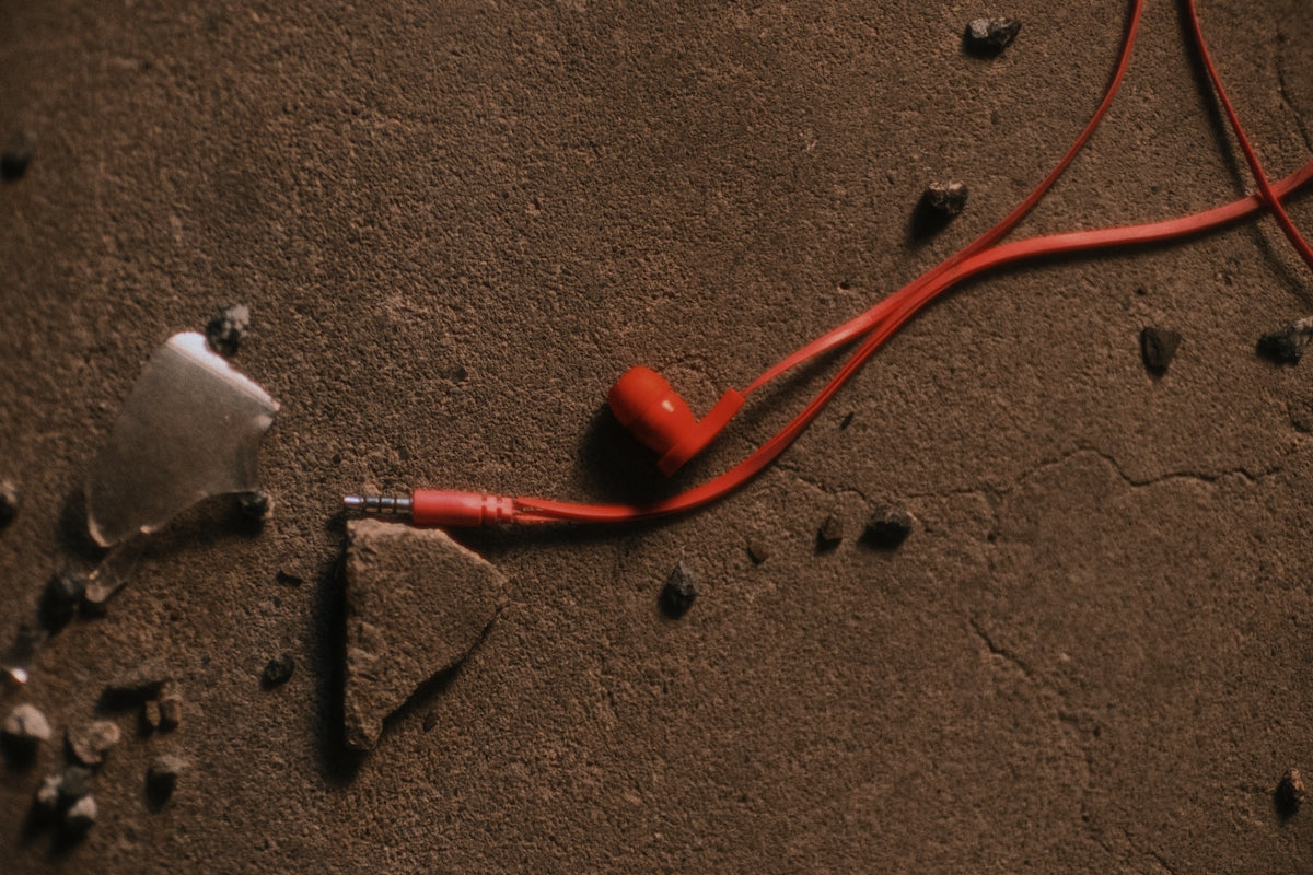 A pair of red wires laying on top of a floor