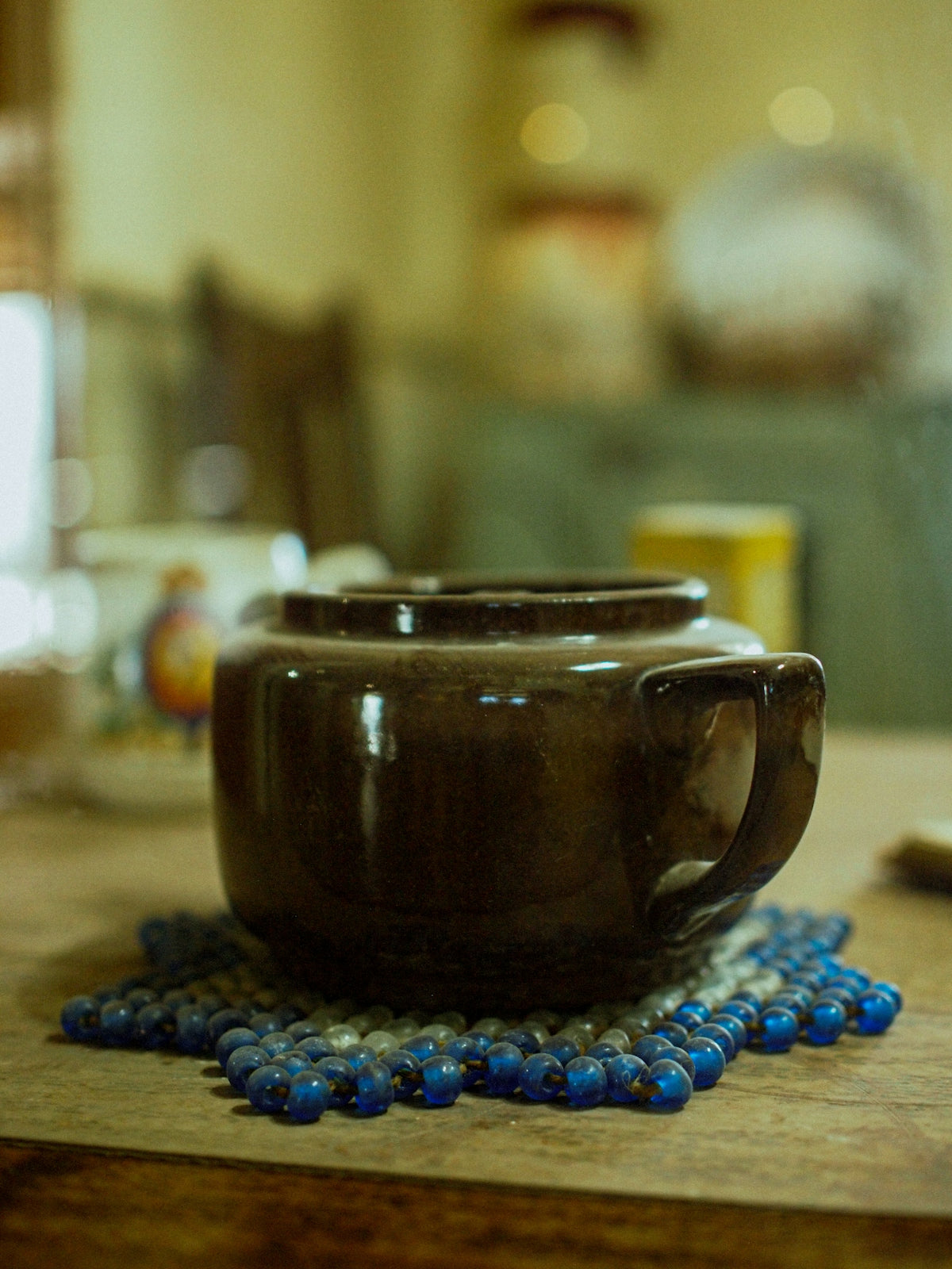 A brown cup sitting on top of a wooden table
