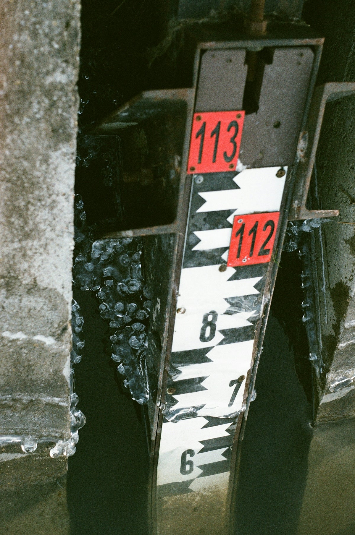 A close up of a street sign on the side of a building