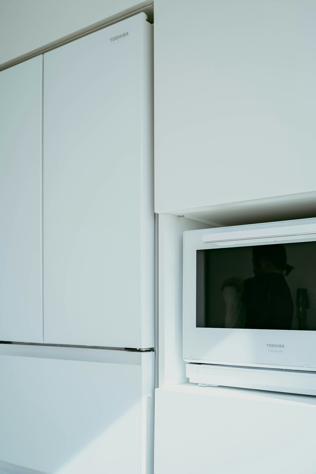 A microwave is built into the wall of a kitchen
