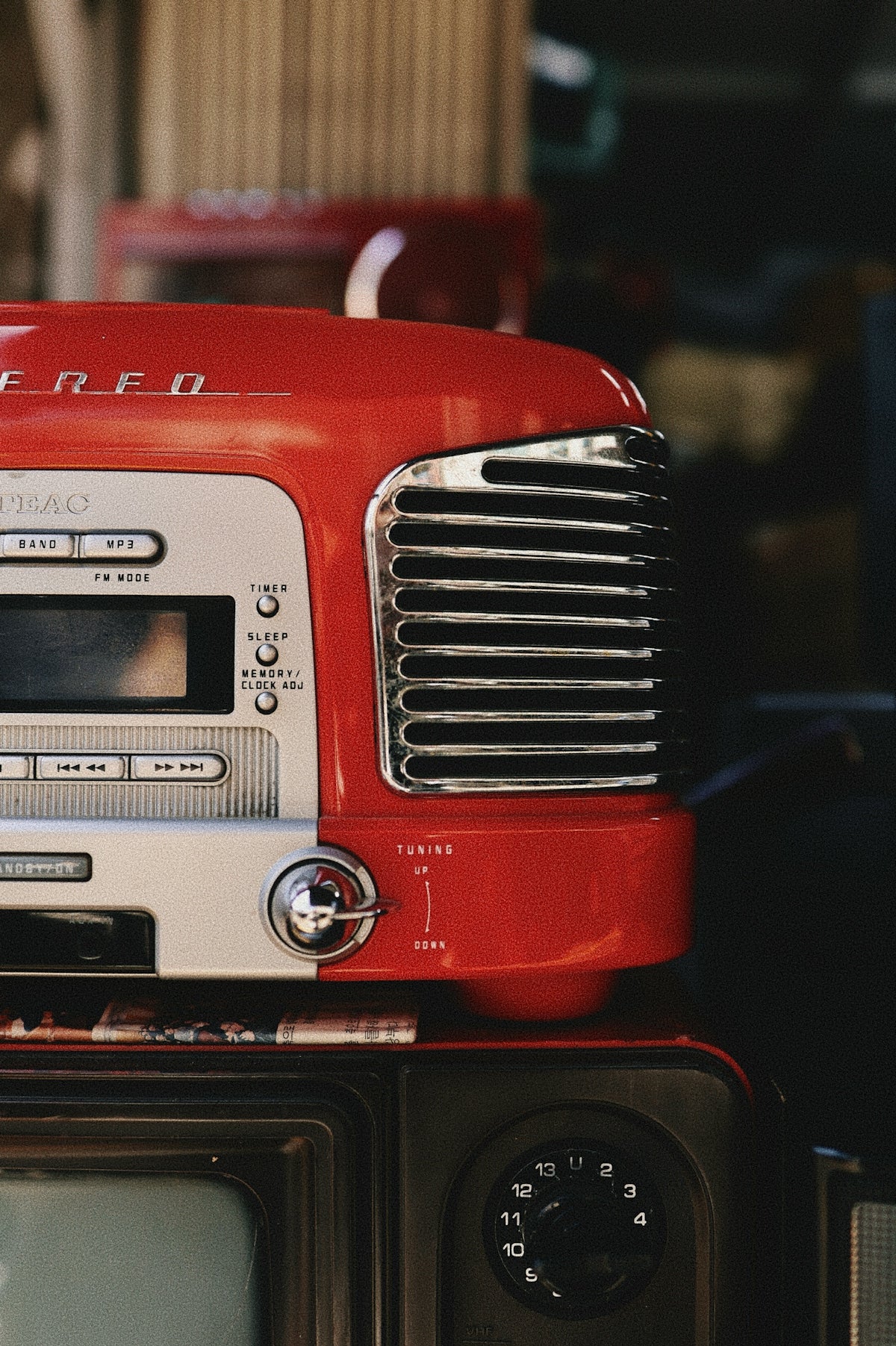 A vintage red stereo on top of a tv.