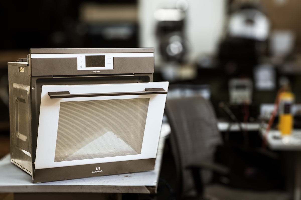 An oven is open in a kitchen.